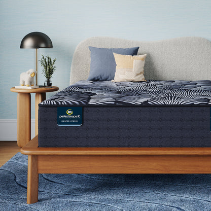 Perfect Sleeper X Quilted Hybrid Excelled Plush Mattress sitting in a brown bedframe || feel: Enhanced Plush || level: Level 1