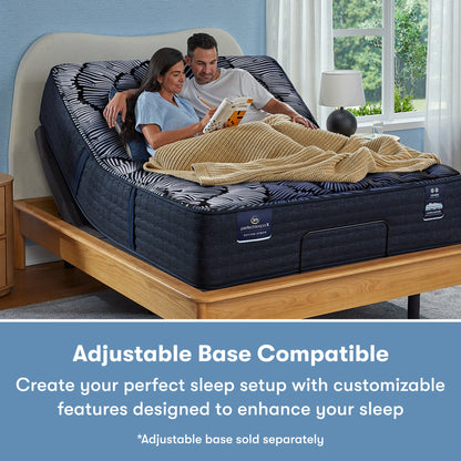 Man and woman sitting in a Perfect Sleeper X Quilted Hybrid Max Firm Pillow Top Mattress sitting in an adjustable base frame || feel: Firm Pillow Top || level: Level 2