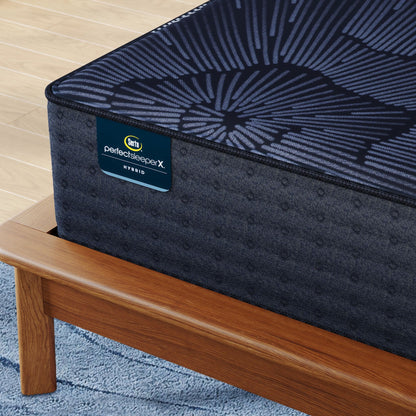 Corner of Perfect Sleeper X Hybrid Prescot Plush Mattress sitting in a brown bedframe || feel: Plush || level: Level 2