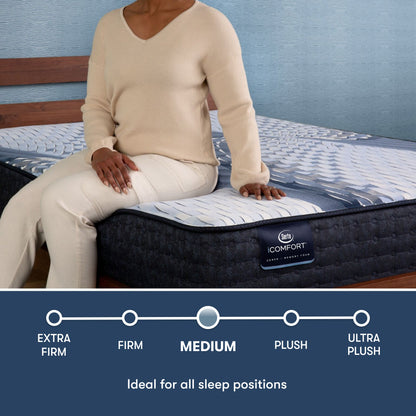 Woman sitting on the side of an iComfort Aveda Medium Mattress || feel: medium || level: Standard - 12"