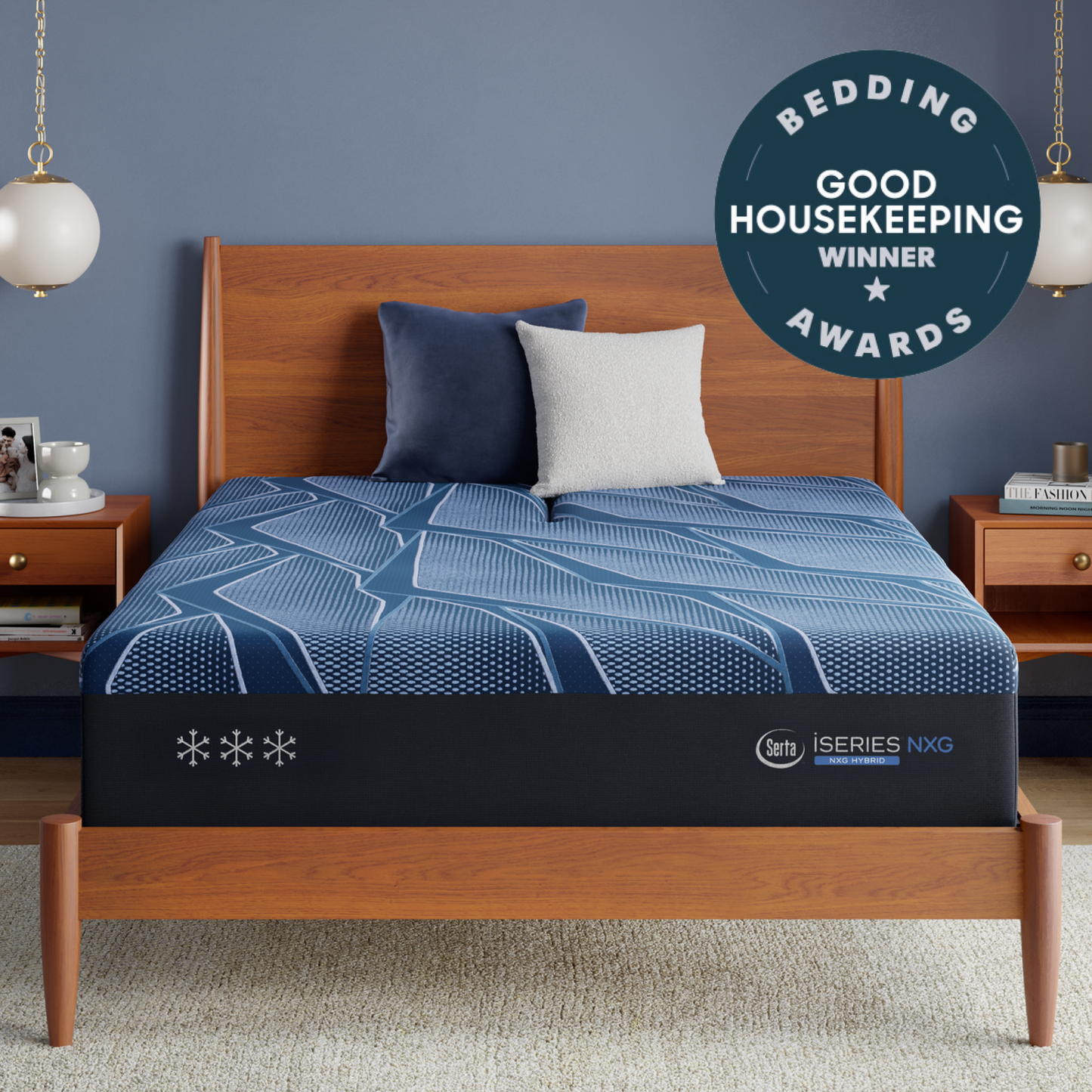 A Blue Serta® iSeries® NXG™ Mattress shown on a wooden bed frame in a styled bedroom setting, featuring a blue and white patterned bedding cover, two pillows, bedside tables, and a circular award badge overlay.