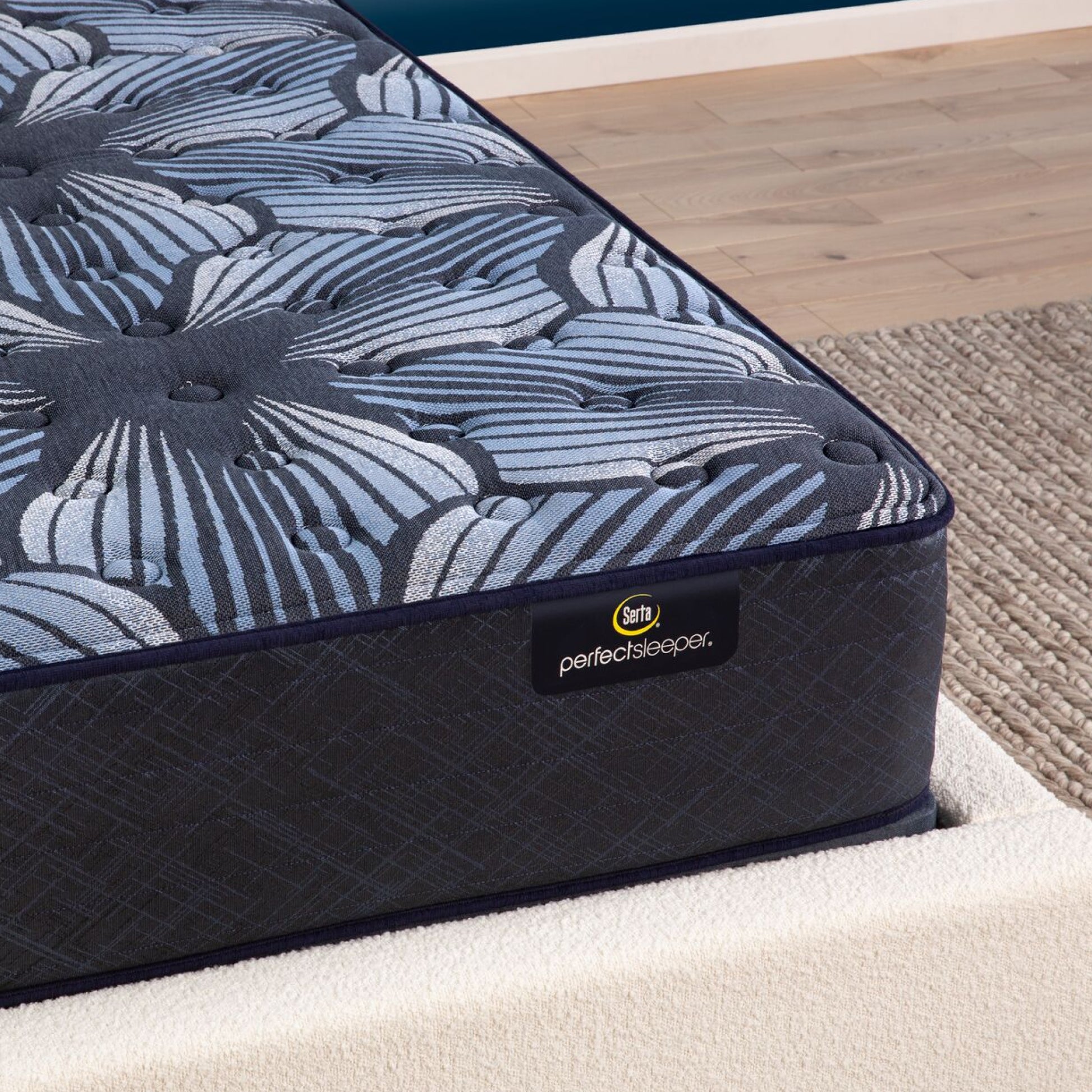 Corner view of the  Serta Perfect Sleeper Sleep Excellence mattress in a bedroom | feel: Extra Firm