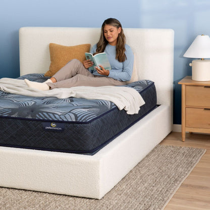 A woman reading in bed on the Serta Perfect Sleeper Sleep Excellence mattress | feel: Firm