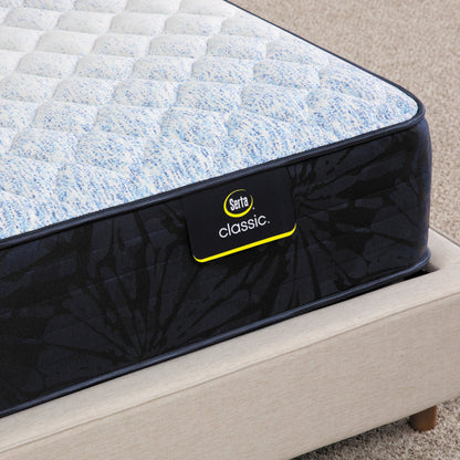 Corner of Serta classic dorian firm mattress sitting in a beige bed frame ||feel: firm ||level: standard