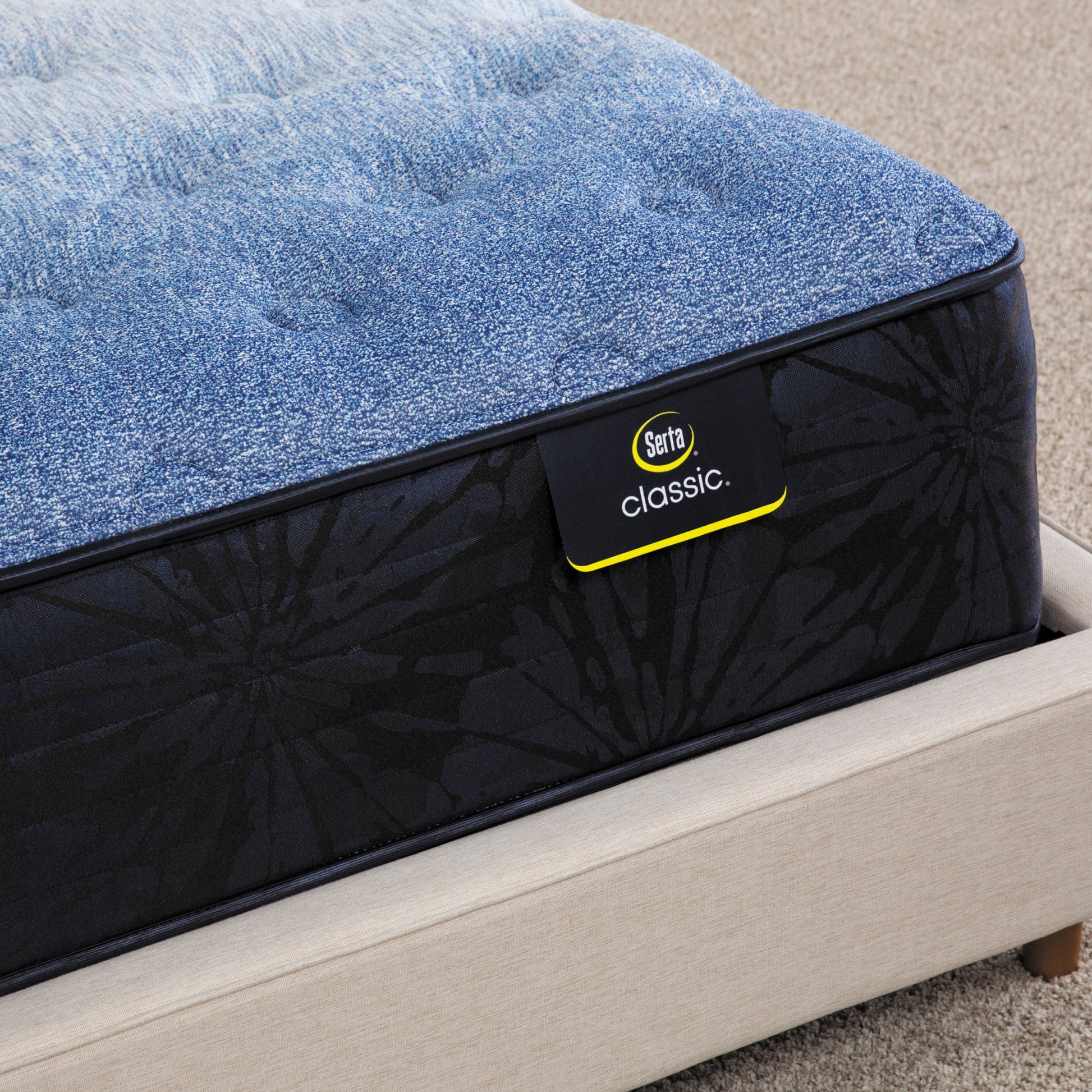 Corner of Serta classic brecon medium mattress sitting in a beige bed frame ||feel: medium ||level: enhanced