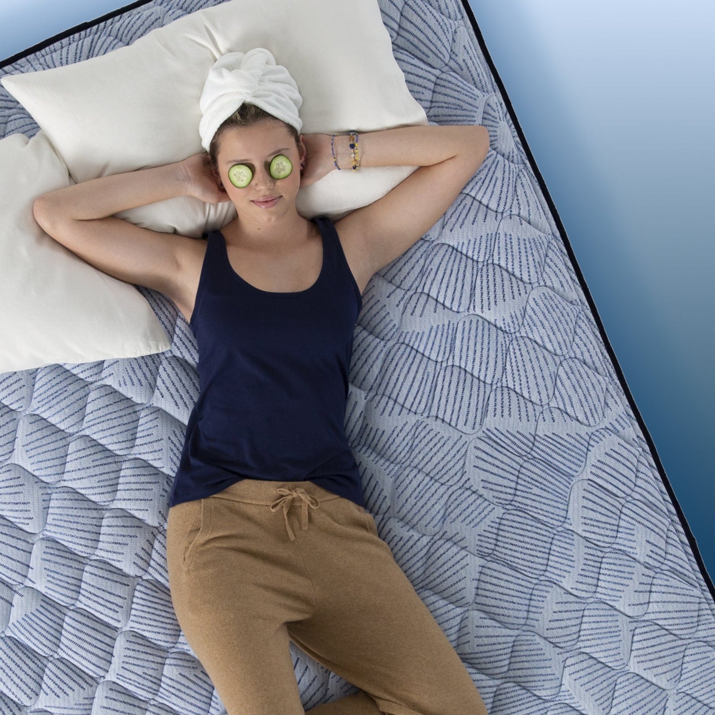 Girl lounging in bed on a Serta Perfect Sleeper mattress||feel: firm||level: enhanced